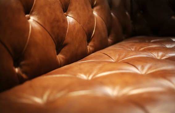 Masculine leather couch aesthetic. Light, tan, brown textured leather sofa used for interior designs by Lucy Stuefloten. 