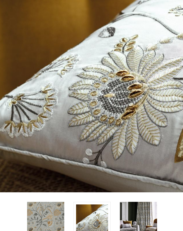 A fancy, embroidered pillow with a lotus flower. Showing some luxury interior design mistakes most homeowners make.