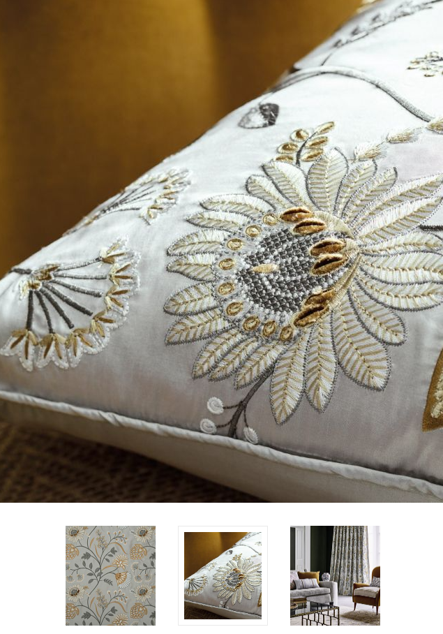 A fancy, embroidered pillow with a lotus flower. Showing some luxury interior design mistakes most homeowners make.