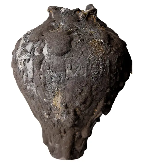 A decorative art vase, that looks like a clump of brownish-grey mud. 
